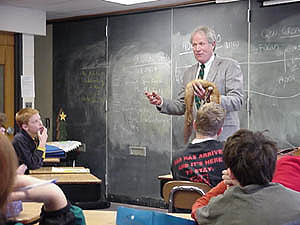 Author John Mitchell working with students